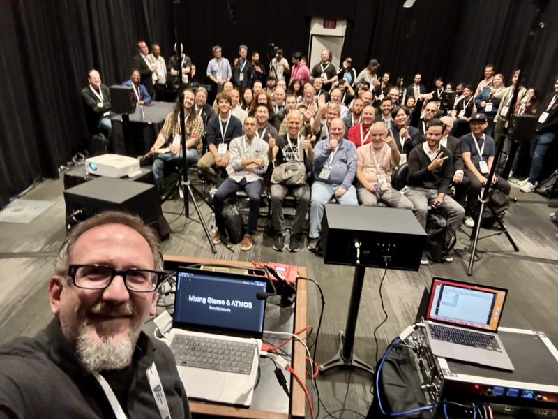 Matt Boudreau presenting to a full room at AES in New York, slide reading Mixing Stereo and ATMOS.